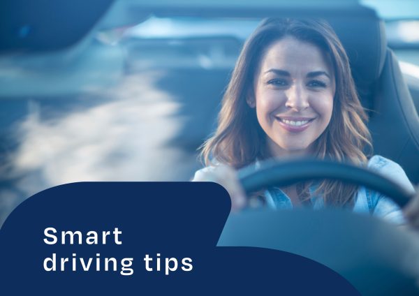 Woman smiling while driving a car. Copy saying 